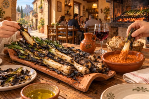 Grilled Catalan calçots served with romesco sauce at a rustic restaurant in Spain.