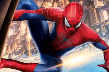 Spider-Man in a red and blue web-patterned suit crouches against a sunlit New York City skyline.